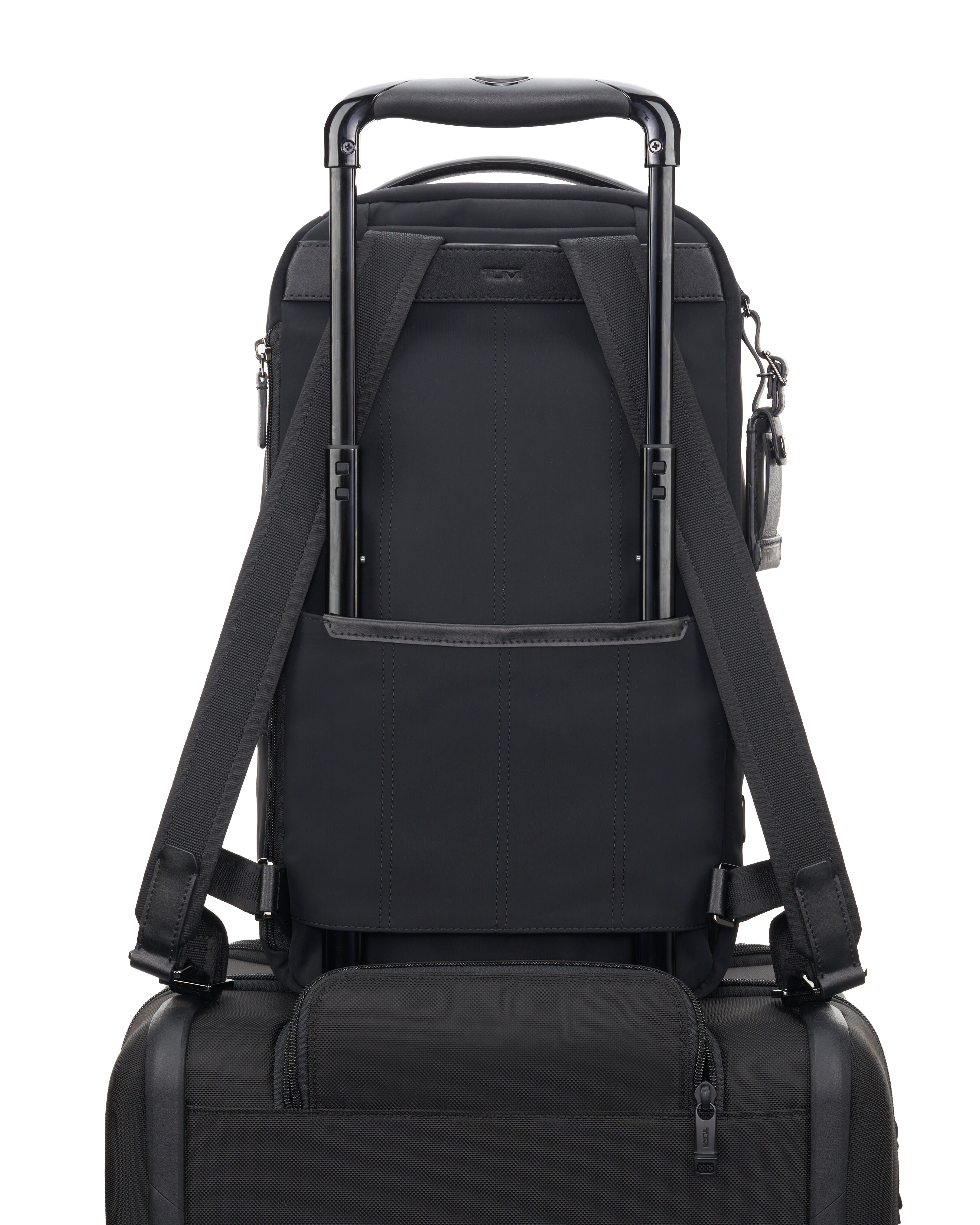 Backpack that slips over suitcase shop handle